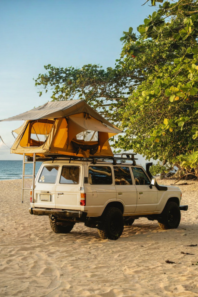 Rooftop Beach Camper in the Philippines ooftop camper parked on a remote beach in the Philippines, perfect for beach camping